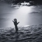 Hand Reaching Out From Ocean Under Dramatic Sky, Symbolizing Struggle And Hope.
