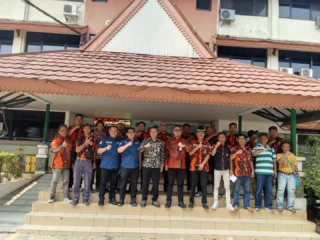 Group Photo At Harian Terbit Office, Featuring People In Vibrant Attire.