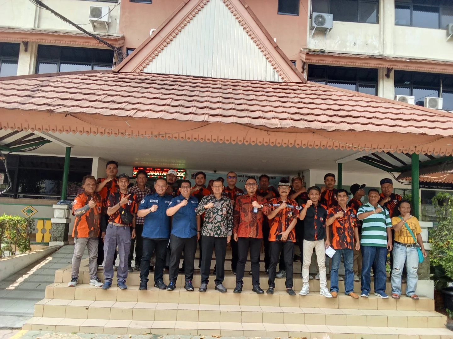 Group Photo At Harian Terbit Office, Featuring People In Vibrant Attire.